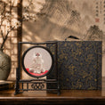Load image into Gallery viewer, Double-sided embroidery of a fluffy grey cat sitting on a red cushion in a round frame within a rectangular hardwood screen stand with scroll-carved base