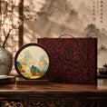 Load image into Gallery viewer, Landscape embroidery ornament beside a red and black brocade dragon pattern carrying gift case on a wooden altar table