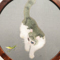 Load image into Gallery viewer, Round double-sided embroidery on hardwood stand showing white and gray cat reaching toward a green grasshopper on gray silk background