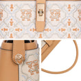 Bild in Galerie-Betrachter laden, Multi-panel close-up detail shot of two-tone leather handbag, showcasing intricate traditional auspicious deer geometric embroidery, vintage gold twist lock, sturdy metal side D-ring hardware and smooth leather top handle stitching