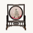Load image into Gallery viewer, Double-sided embroidery of a fluffy grey cat sitting on a red cushion in a round frame within a rectangular hardwood screen stand with scroll-carved base