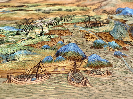 Suzhou embroidery inspired by A Thousand Li of Rivers and Mountains, featuring layered mountains, rivers, boats, and intricate silk threadwork.