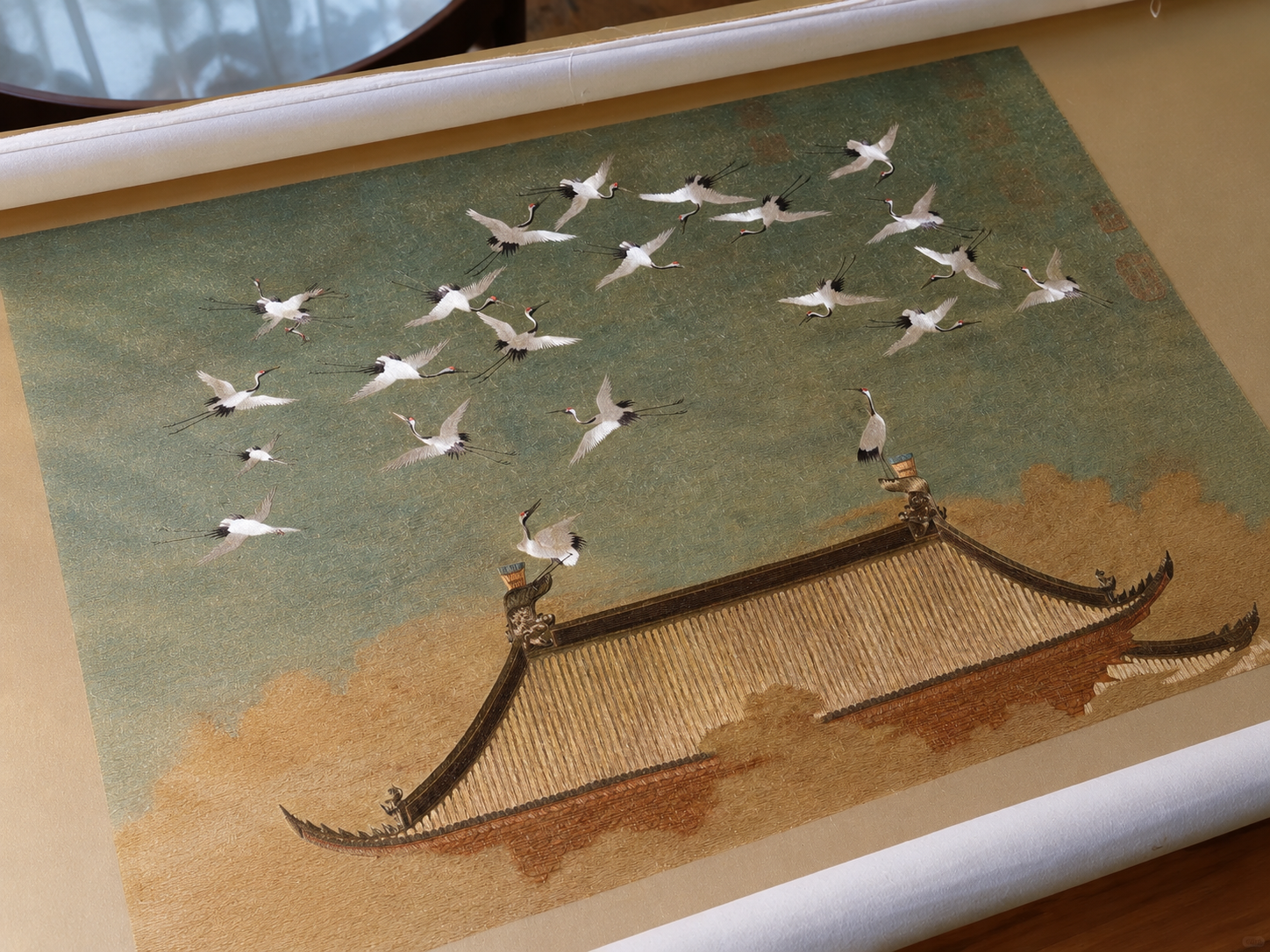 Handcrafted Suzhou embroidery of Emperor Huizong’s Auspicious Cranes (Ruihe Tu), depicting white cranes above a traditional Chinese palace