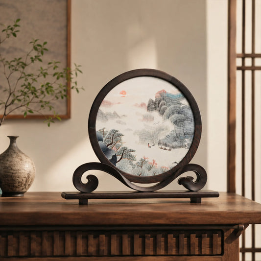 Round double-sided embroidery on carved rosewood stand depicting Chinese mountain landscape with pine trees, red sun, and river boats on silk
