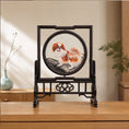 Load image into Gallery viewer, Double-sided embroidery of a brown and white Pekingese dog standing on a rock in a circular frame within a rectangular hardwood screen stand
