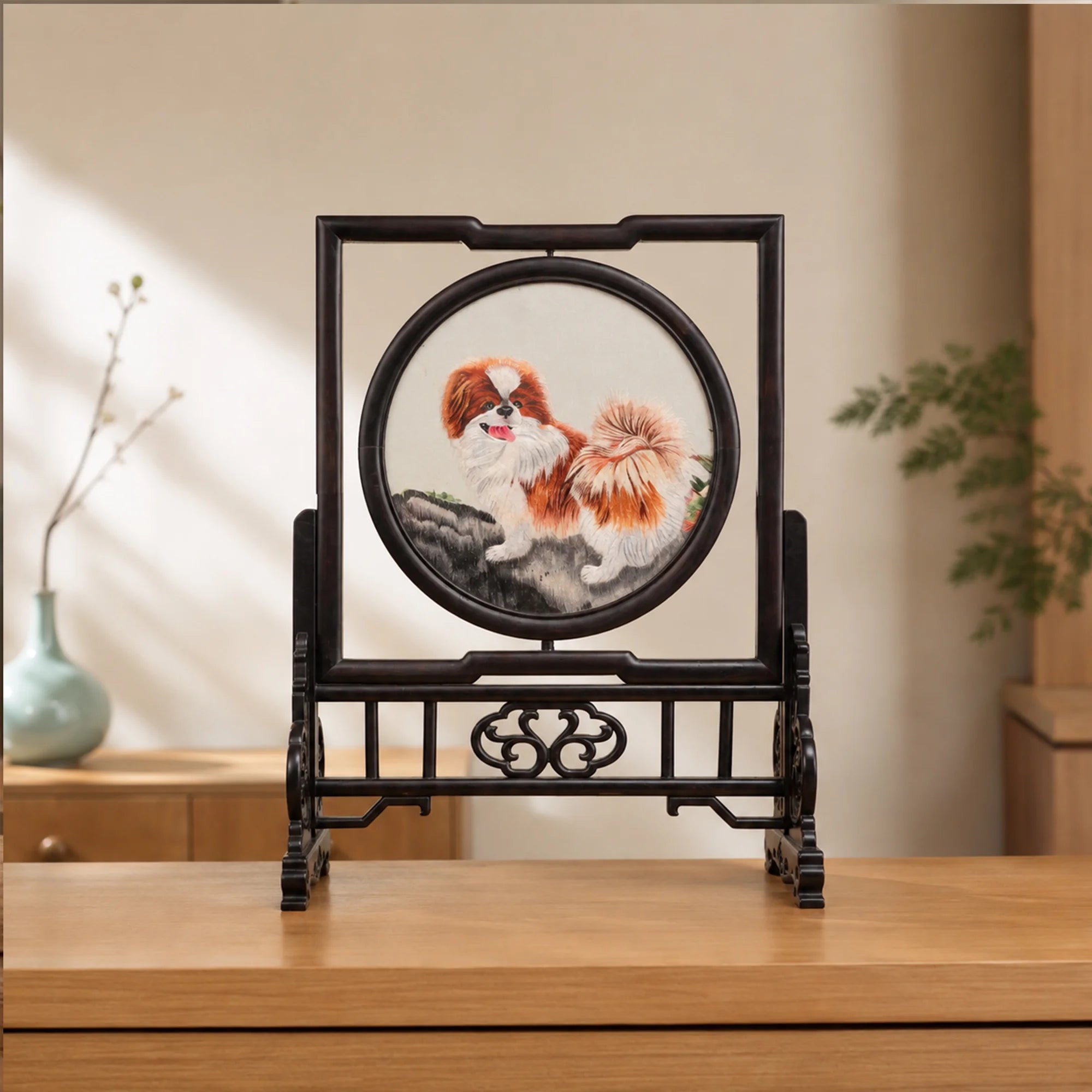 Double-sided embroidery of a brown and white Pekingese dog standing on a rock in a circular frame within a rectangular hardwood screen stand