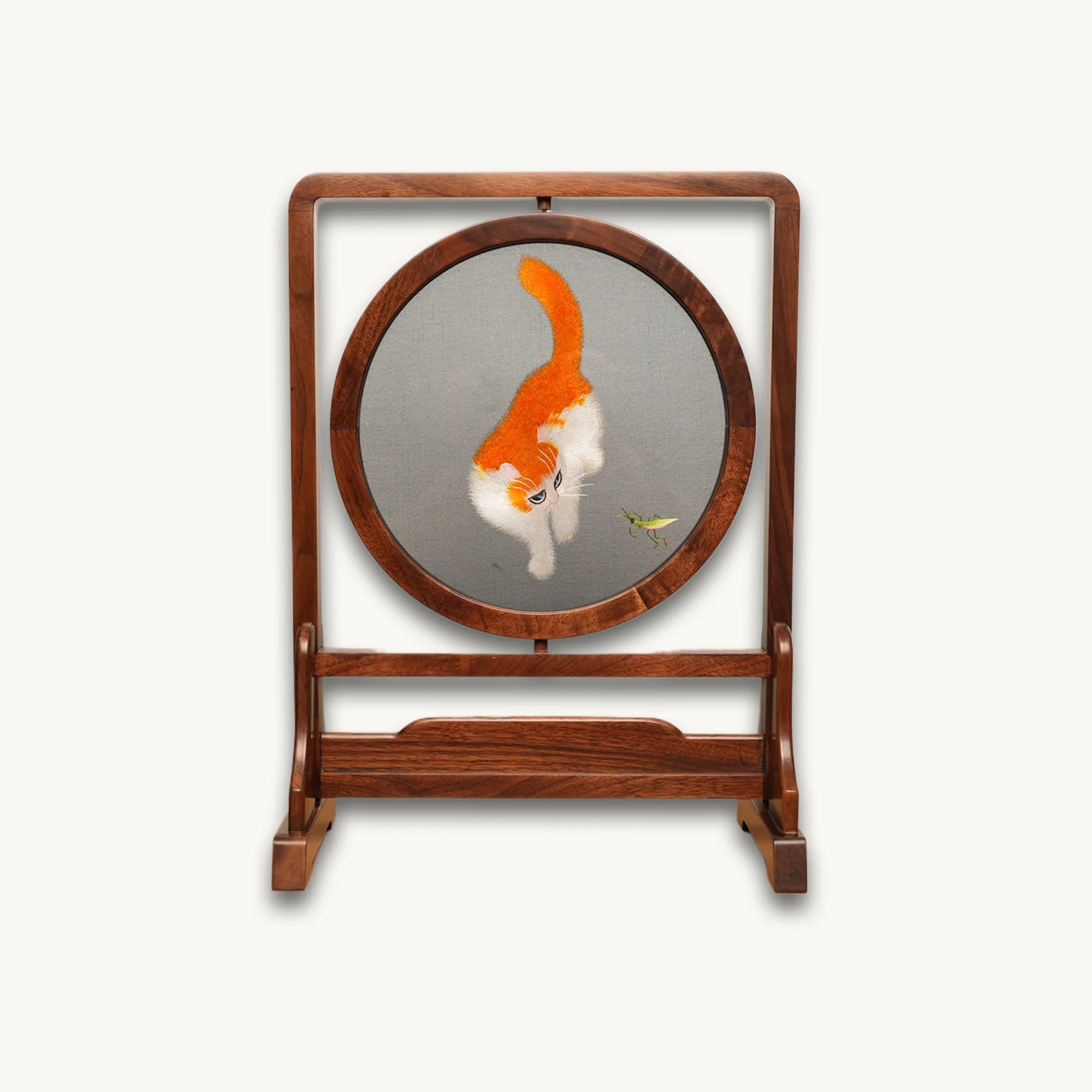 Reverse side of double-sided embroidery featuring orange and white cat in same playful pose with grasshopper on gray silk