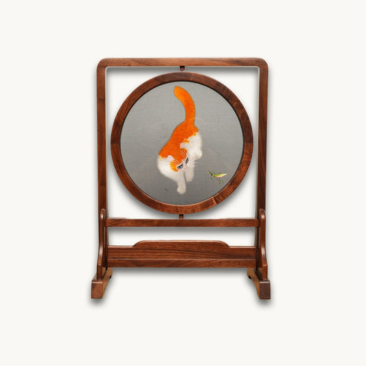 Reverse side of double-sided embroidery featuring orange and white cat in same playful pose with grasshopper on gray silk