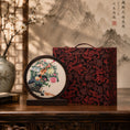 Load image into Gallery viewer, Pheasant embroidery ornament beside a red and black brocade dragon pattern carrying gift case on a carved wooden table
