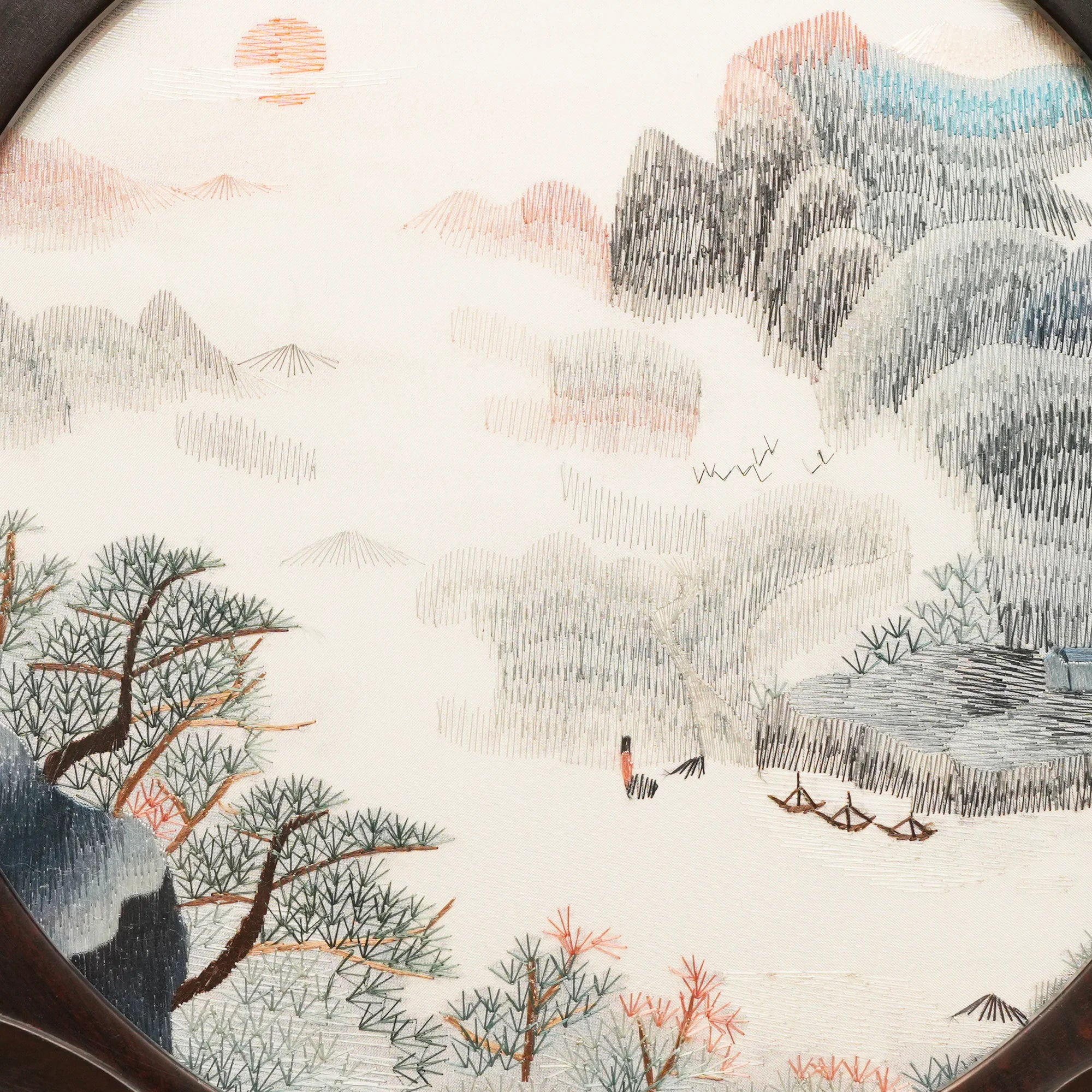 Round double-sided embroidery on carved rosewood stand depicting Chinese mountain landscape with pine trees, red sun, and river boats on silk