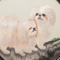 Load image into Gallery viewer, Reverse side of double-sided embroidery showing two fluffy white Pekingese dogs together in a circular silk frame on a carved wooden stand
