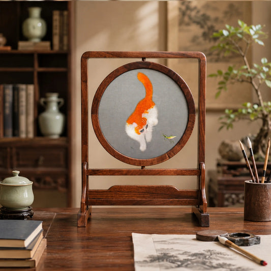Reverse side of double-sided embroidery featuring orange and white cat in same playful pose with grasshopper on gray silk