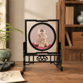 Load image into Gallery viewer, Double-sided embroidery of a fluffy grey cat sitting on a red cushion in a round frame within a rectangular hardwood screen stand with scroll-carved base
