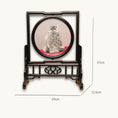 Load image into Gallery viewer, Double-sided embroidery of a fluffy grey cat sitting on a red cushion in a round frame within a rectangular hardwood screen stand with scroll-carved base
