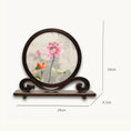 Load image into Gallery viewer, Double-sided embroidery of pink and orange lotus blossoms with green leaves in a round dark hardwood frame on a scroll-carved wooden stand
