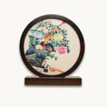 Load image into Gallery viewer, Double-sided embroidery of a golden pheasant on a rock surrounded by colorful peonies in a round dark wood frame on wooden stand
