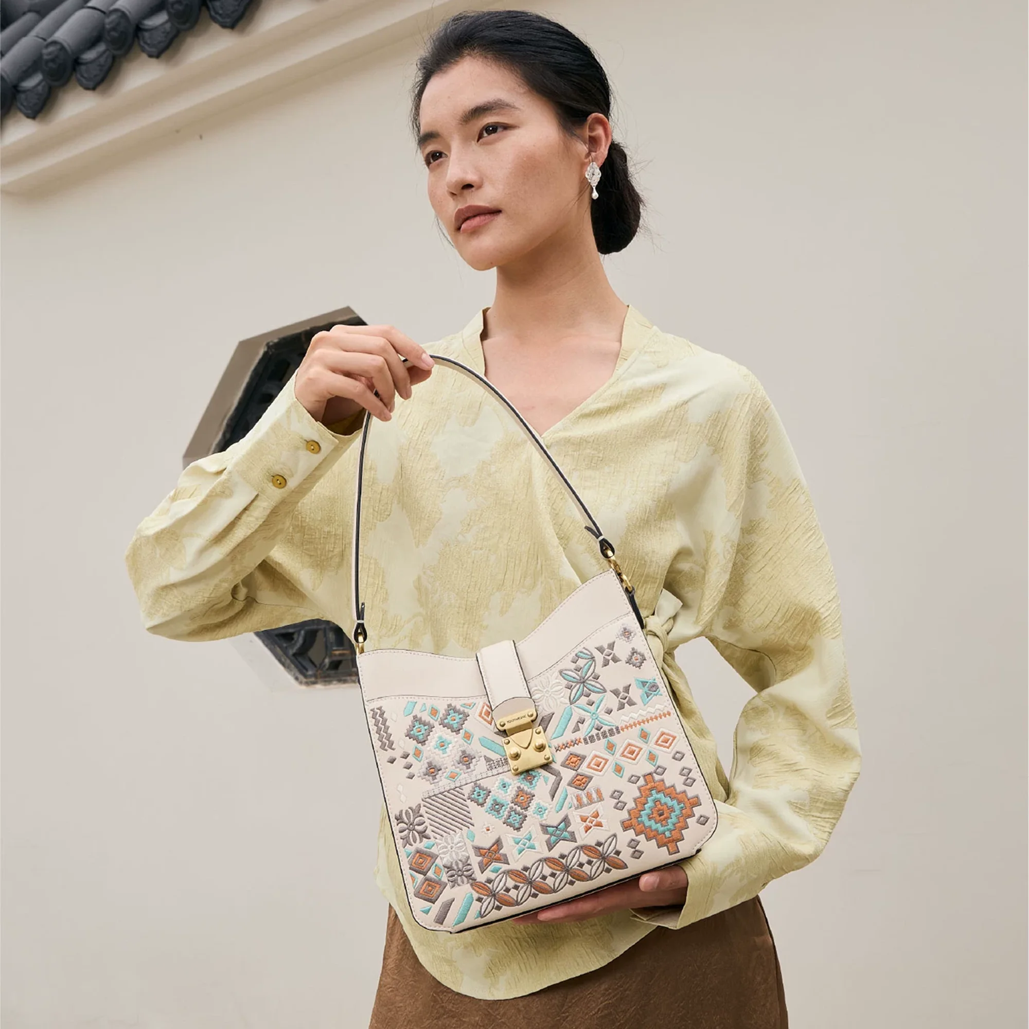 Luxury Chinese embroidery crossbody bag with traditional geometric patterns, inspired by Chinese heritage motifs and Ru porcelain blue tones, blending oriental elegance with modern minimalist fashion