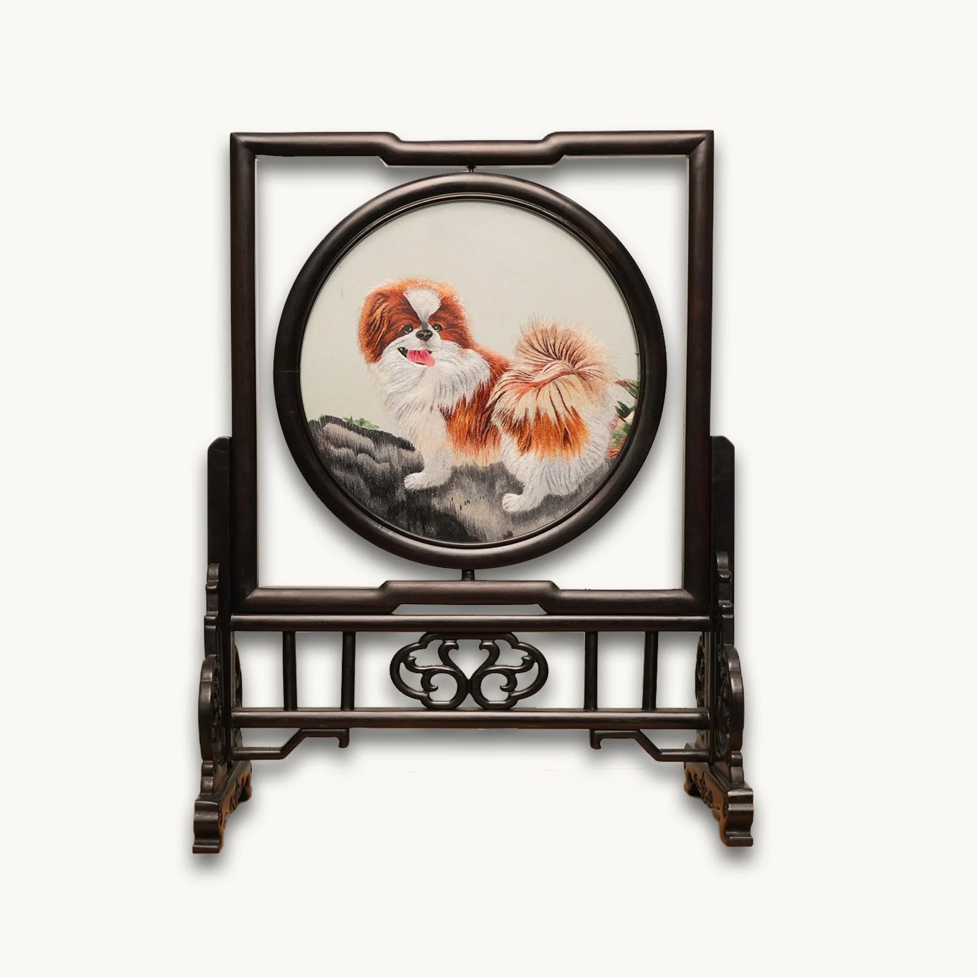 Double-sided embroidery of a brown and white Pekingese dog standing on a rock in a circular frame within a rectangular hardwood screen stand