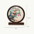 Load image into Gallery viewer, Double-sided embroidery of a golden pheasant on a rock surrounded by colorful peonies in a round dark wood frame on wooden stand

