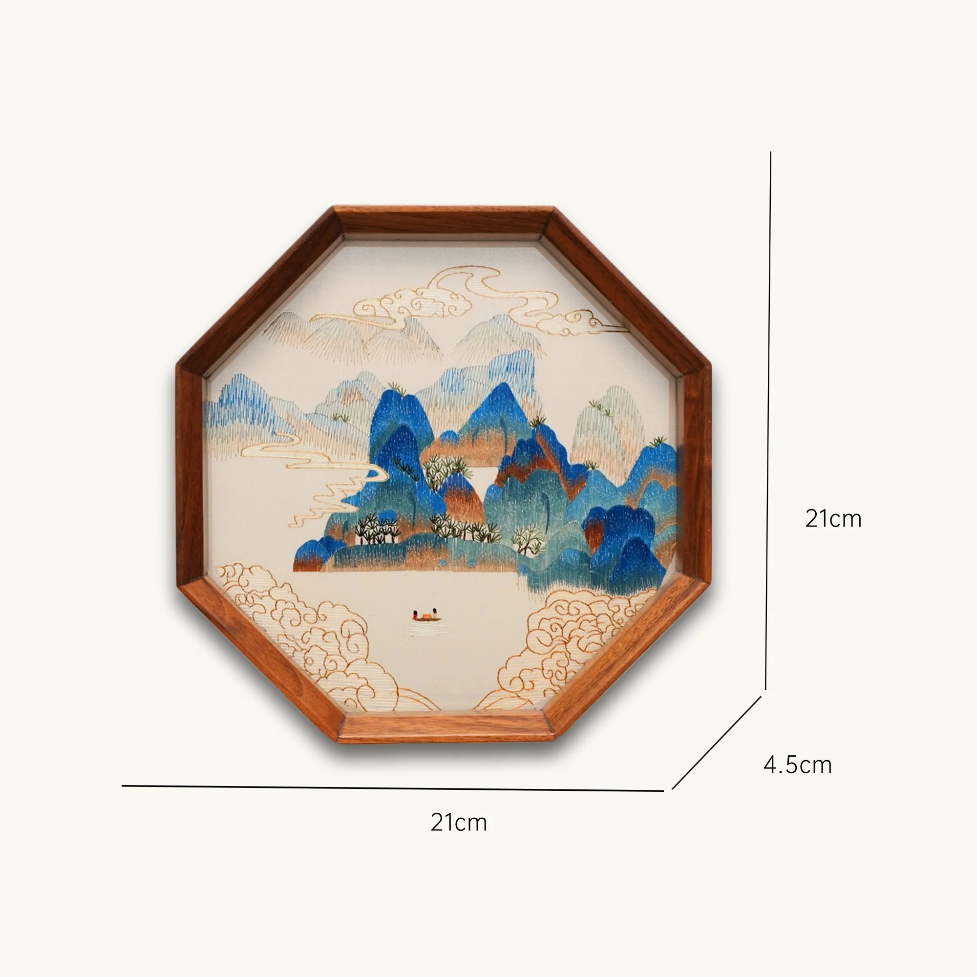 Double-sided embroidery of a blue green mountain landscape with clouds and a boat in an octagonal wooden frame