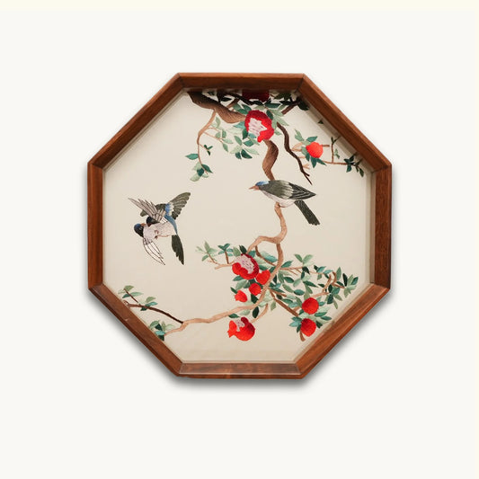 Double-sided embroidery of three birds among red pomegranate flowers and fruit in an octagonal hardwood frame on cream silk