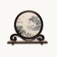Load image into Gallery viewer, Round double-sided embroidery on carved rosewood stand depicting Chinese mountain landscape with pine trees, red sun, and river boats on silk

