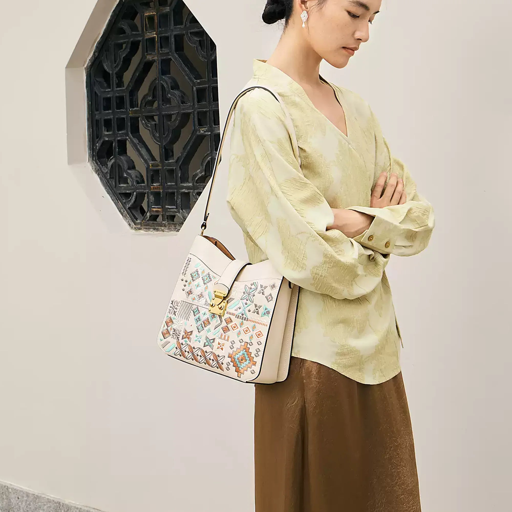 Luxury Chinese embroidery crossbody bag featuring traditional geometric motifs inspired by Chinese heritage craftsmanship, blending oriental elegance with modern minimalist fashion