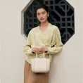 Load image into Gallery viewer, SinoCrafted Suzhou embroidery handbag with elegant floral patterns, held by a woman in a modern Chinese-inspired setting.
