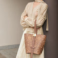 Load image into Gallery viewer, SinoCrafted brown scrolling vine embroidery tote bag styled over the shoulder, showcasing intricate Chinese-inspired embroidered details.
