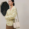 Load image into Gallery viewer, SinoCrafted Suzhou embroidery crossbody handbag with delicate floral patterns, styled by a woman in a modern Chinese-inspired setting.
